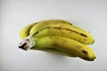 Cluster of blemished bananas on white background Royalty Free Stock Photo