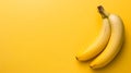 Ripe bananas rests atop a cheerful yellow backdrop