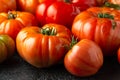 Ripe Beefsteak Tomatoes on rustic black table Royalty Free Stock Photo