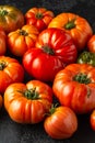 Ripe Beefsteak Tomatoes on rustic black table Royalty Free Stock Photo