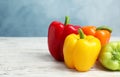 Ripe bell peppers on white wooden table against light blue background Royalty Free Stock Photo