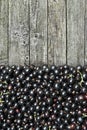 Ripe berries of a black currant on the wooden background Royalty Free Stock Photo
