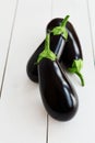 Ripe black eggplant, aubergine, guinea squash on wooden table Royalty Free Stock Photo