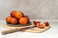 Ripe bloody Sicilian orange sliced on a cutting board. Blood orange slices and a knife