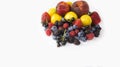 Ripe blueberries, raspberries, black currants, blackberries, strawberries, yellow plums and peaches on white background.