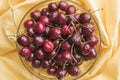 Ripe bright cherry with droplets of water in a transparent bowl Royalty Free Stock Photo