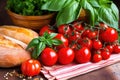 ripe, bright red tomatoes and bundle of fresh basil next to bruschetta