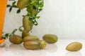 Ripe burgundy green finger-shaped citrus fruits on the dinner table, close-up. Indoor growing of the outlandish citrus plant