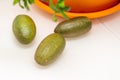 Ripe burgundy green finger-shaped citrus fruits on the dinner table, close-up. Indoor growing of the outlandish citrus plant