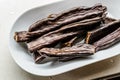 Ripe Carob Pods in Plate Ready to Eat Royalty Free Stock Photo