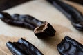 Ripe Carob Pods on wooden surface. Royalty Free Stock Photo