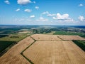 Ripe cereals on a farm field in summer, top view. Clear blue sky over the fields, landscape from a bird\'s eye view Royalty Free Stock Photo