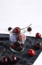 Ripe cherries Glass jar Homemade preseved cheery jam Summer harvesting checkered napkin White background Closeup Vertical Royalty Free Stock Photo