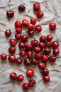 Ripe cherries scattered on crumpled linen textile