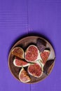 Tasty and ripe chopped figs on a purple wooden surface
