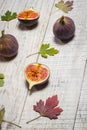 Ripe chopped figs on a white wooden surface