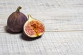 Ripe chopped figs on a white wooden surface