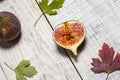 Ripe chopped figs on a white wooden surface