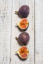 Ripe chopped figs on a white wooden surface