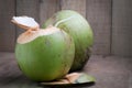 Ripe coconut and juice on wood floor. Royalty Free Stock Photo