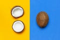 Ripe coconut on yellow and blue colored background, minimal flat lay style top view with copy space. Pop art design, creative Royalty Free Stock Photo