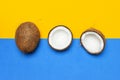 Ripe coconut on yellow and blue colored background, minimal flat lay style top view with copy space. Pop art design, creative Royalty Free Stock Photo