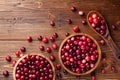 Ripe cranberry in wooden bowl on rustic table from above Royalty Free Stock Photo