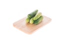 Ripe cucumber on chopping board white background Royalty Free Stock Photo