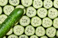 Ripe cucumber and sliced cucumber slices on a dark background, top view Royalty Free Stock Photo
