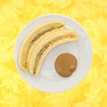 Ripe cut banana and a portion of peanut butter