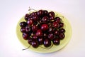 Ripe dark red cherries on plate Royalty Free Stock Photo