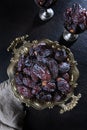 Ripe dates on a platter. Juicy dried fruits. Healthy food. Fast food. Food for vegetarians. Vertical photo