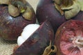 Ripe delicious mangosteen whole fruits and sliced on patch of hemp bag close up photo