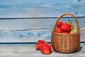 Ripe delicious strawberries in a wicker basket on old wooden table Royalty Free Stock Photo