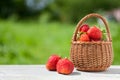 Ripe delicious strawberries in a wicker basket on an old wooden table Royalty Free Stock Photo