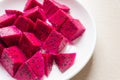 Ripe dragon fruit isolated on white background. Sweet pitaya on a plate, space for text