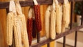 Ripe dried corn cobs hanging on the old wooden wagon