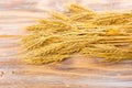 Wheat Ears on the Wooden Table. Sheaf of Wheat over Wood Background. Harvest concept Royalty Free Stock Photo