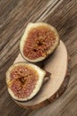 Ripe fig fruit cut in half on a wooden table Royalty Free Stock Photo