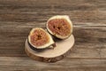 Ripe fig fruit cut in half on a wooden table Royalty Free Stock Photo