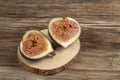 Ripe fig fruit cut in half on a wooden table Royalty Free Stock Photo