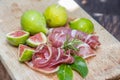 Ripe fig fruits and bacon or prosciutto. Food to accompany the d