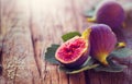 Ripe fig fruits with leaf close-up. Beautiful sweet fresh organic figs on a wooden table. Border label design. Healthy food Royalty Free Stock Photo