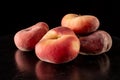 Ripe flat peaches on a black background close up Royalty Free Stock Photo