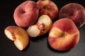 Ripe flat peaches on a black background close up Royalty Free Stock Photo