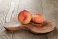 Ripe flat peaches on olive board Royalty Free Stock Photo