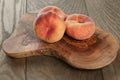 Ripe flat peaches on olive board Royalty Free Stock Photo