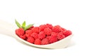 Delicious juicy forest raspberry on a plastic spoon on an isolated white background. Royalty Free Stock Photo