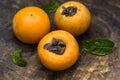 Ripe fragrant sweet persimmons laid out on old wooden boards