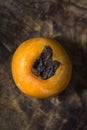 Ripe fragrant sweet persimmons laid out on old wooden boards